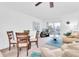 Open-concept living room featuring a comfortable seating area, dining space, and sliding glass doors to the outside at 10365 Paradise Blvd # 4, Treasure Island, FL 33706