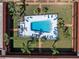 Aerial view of fenced community pool featuring lounge chairs and lush landscaping at 10365 Paradise Blvd # 4, Treasure Island, FL 33706