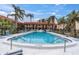 Community pool with palm trees and seating at 10365 Paradise Blvd # 4, Treasure Island, FL 33706