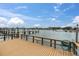 Waterfront deck with wood floors and railing featuring boat dock views and a water hose at 10365 Paradise Blvd # 4, Treasure Island, FL 33706