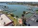 Waterfront view of building featuring docks, bay access, patio and well manicured lawn at 10365 Paradise Blvd # 4, Treasure Island, FL 33706