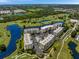 Stunning aerial view of condominiums, golf course, ponds, and verdant surroundings at 1200 Country Club Dr # 5404, Largo, FL 33771