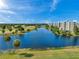 Beautiful aerial view of a building overlooking a well-maintained golf course and a scenic body of water at 1200 Country Club Dr # 5404, Largo, FL 33771
