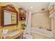 Well-lit bathroom featuring a soaking tub, vanity with a granite countertop, and decorative accents at 1200 Country Club Dr # 5404, Largo, FL 33771