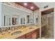 Bathroom featuring granite countertops, dual sinks, a walk-in shower, and unique design at 1200 Country Club Dr # 5404, Largo, FL 33771