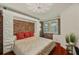 Comfortable bedroom featuring a decorative brick wall and a modern ceiling fan at 1200 Country Club Dr # 5404, Largo, FL 33771