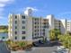 Elegant condo building exterior featuring yellow accents, multiple balconies, and well-maintained parking area at 1200 Country Club Dr # 5404, Largo, FL 33771
