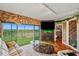 Beautifully appointed living room featuring a balcony, stone accent wall, fireplace and stylish decor at 1200 Country Club Dr # 5404, Largo, FL 33771