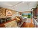 Spacious living area with stone accent wall, wet bar, hardwood floors, and balcony access at 1200 Country Club Dr # 5404, Largo, FL 33771