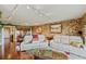 Bright, open living room with stone accent wall, comfortable seating, and access to wet bar at 1200 Country Club Dr # 5404, Largo, FL 33771