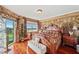 Luxurious main bedroom with stone accent wall, hardwood floors, and serene views at 1200 Country Club Dr # 5404, Largo, FL 33771