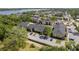Aerial view of property with mature trees, pool, and lake views at 12293 Sailwinds Dr # 206, Largo, FL 33773