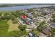 Aerial view of condos with a pool, parking, and a lake nearby at 12293 Sailwinds Dr # 206, Largo, FL 33773
