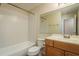 Clean bathroom featuring a tub and shower combo, toilet, and wood vanity at 12293 Sailwinds Dr # 206, Largo, FL 33773