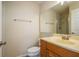 Well-lit bathroom featuring a shower, large mirror, and wooden vanity at 12293 Sailwinds Dr # 206, Largo, FL 33773