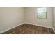 Light-filled bedroom with a window, neutral walls, and wood-look flooring at 12293 Sailwinds Dr # 206, Largo, FL 33773