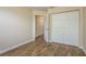 Bedroom featuring vinyl floors, neutral walls, and closet with double doors at 12293 Sailwinds Dr # 206, Largo, FL 33773