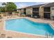 View of the community pool with chairs and tables at 12293 Sailwinds Dr # 206, Largo, FL 33773