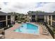Community pool with lounge chairs and nearby residential buildings at 12293 Sailwinds Dr # 206, Largo, FL 33773