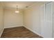 Dining room area featuring a modern lighting fixture and storage closet at 12293 Sailwinds Dr # 206, Largo, FL 33773