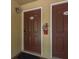 Condo entrance doors with unit numbers, a wall light, and a fire extinguisher at 12293 Sailwinds Dr # 206, Largo, FL 33773