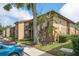 Apartment building exterior with greenery, sidewalk and parking at 12293 Sailwinds Dr # 206, Largo, FL 33773