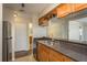 Well-lit kitchen featuring stainless steel appliances, double sink, and light wood cabinets at 12293 Sailwinds Dr # 206, Largo, FL 33773