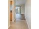 Open concept living room with light tile floors and a sliding glass door at 12293 Sailwinds Dr # 206, Largo, FL 33773