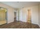Spacious main bedroom featuring wood-look flooring, large window, and ensuite bathroom at 12293 Sailwinds Dr # 206, Largo, FL 33773