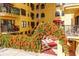 Exterior view of a condo building with a courtyard and orange flowers at 130 4Th N Ave # 608, St Petersburg, FL 33701