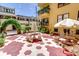 Courtyard featuring red and white pavers, benches, tables, and an umbrella at 130 4Th N Ave # 608, St Petersburg, FL 33701