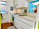 Modern kitchen featuring white cabinets and countertop, stainless steel appliances, and a compact design at 130 4Th N Ave # 608, St Petersburg, FL 33701