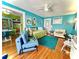 Open living room with vibrant turquoise walls, hardwood floors, and stylish furnishings at 130 4Th N Ave # 608, St Petersburg, FL 33701