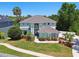 Aerial view of a two-story home with lush landscaping and a gray roof at 13310 Waterford Run Dr, Riverview, FL 33569