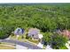 Aerial view of a neighborhood near a lush forest at 13310 Waterford Run Dr, Riverview, FL 33569