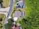A high angle aerial view of homes with pools, solar panels, landscaping and neighborhood streets at 13310 Waterford Run Dr, Riverview, FL 33569