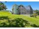 Two-story home with a screened-in pool and jacuzzi surrounded by lush landscaping at 13310 Waterford Run Dr, Riverview, FL 33569