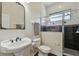 Classic bathroom with a pedestal sink, walk-in shower with black and white tile at 13310 Waterford Run Dr, Riverview, FL 33569