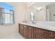 Elegant bathroom with marble countertops, custom wood cabinetry, and natural light at 13310 Waterford Run Dr, Riverview, FL 33569