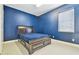 Bedroom featuring blue walls, tile floors, a window, and a wooden bed frame with drawers at 13310 Waterford Run Dr, Riverview, FL 33569