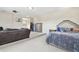 Expansive bonus room featuring carpet, a sitting area, and a luxurious bed for versatile living at 13310 Waterford Run Dr, Riverview, FL 33569