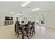 Bonus room with tile flooring, dining table, ceiling fan, TV, and access to outdoor patio at 13310 Waterford Run Dr, Riverview, FL 33569