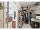 A spacious walk-in closet with custom shelving and an attached bathroom, offering luxury and convenience at 13310 Waterford Run Dr, Riverview, FL 33569