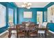 The dining room features blue walls, wood floors, and a dining table at 13310 Waterford Run Dr, Riverview, FL 33569