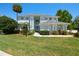 Beautiful two-story home with manicured landscaping, a well-manicured lawn, and a welcoming entrance at 13310 Waterford Run Dr, Riverview, FL 33569