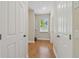 Hallway area featuring wood floors, neutral walls, white trim and doors at 13310 Waterford Run Dr, Riverview, FL 33569