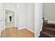 Hallway area featuring hardwood floors, white walls, and a staircase leading upstairs at 13310 Waterford Run Dr, Riverview, FL 33569
