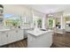Kitchen featuring white cabinets, an island with stone countertops and stainless appliances at 13310 Waterford Run Dr, Riverview, FL 33569