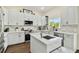 Kitchen featuring white cabinets, an island with stone countertops and stainless appliances at 13310 Waterford Run Dr, Riverview, FL 33569