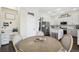 Open kitchen with a dining area featuring white cabinets, an island and stainless appliances at 13310 Waterford Run Dr, Riverview, FL 33569